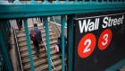 Commuters exit the Wall Street subway station near the New York Stock Exchange (NYSE) in New York, U.S., on Monday, May 14, 2018. U.S. stocks edged higher as trade tensions between the world's two biggest economies showed signs of abating. 