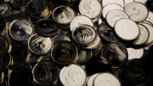 Canadian one dollar coins, also known as Loonies, sit in a pile at the Royal Canadian Mint in Winnipeg, Ontario, Canada, on Friday, July 5, 2013. 