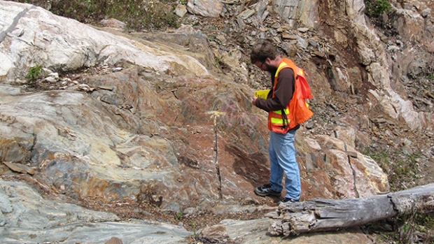 Pistol Bay geologist investigates massive alteration outcrop.