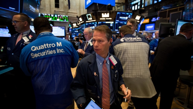 Traders work on the floor of the New York Stock Exchange (NYSE) in New York, U.S., on Monday, June 4, 2018. U.S. stocks reached the highest since mid-March, tracking peers in Europe and Asia as optimism over the world's largest economy helped investors put protectionist fears to one side. 