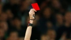 A referee shows a red card during a Champions League soccer match in 2017.