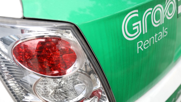 The Grab Rental logo is displayed on the trunk of a car in Singapore, on Thursday, April 26, 2018. Ride-hailing service Grab started a new app in March that will be a single marketplace offering different sharing options for bicycles and electronic-scooters in Singapore, according to a company statement. 