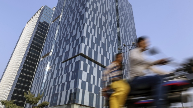 A motorcyclist travels past past GIFT Tower One, left, and GIFT Tower Two in Gujarat International Finance Tec-City (GIFT City), Gujarat, India, on Monday, Jan. 9, 2017. Gift city is targeting the $48 billion in banking activities done by Indian companies and individuals in offshore centers in 2015, estimated to rise to $120 billion by 2025. 