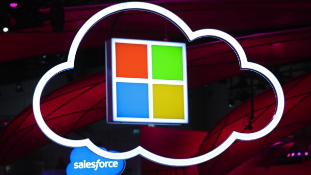 Microsoft Corp. logo, center, hang beside an illuminated iCloud icon at the CeBIT 2017 tech fair in Hannover, Germany. 