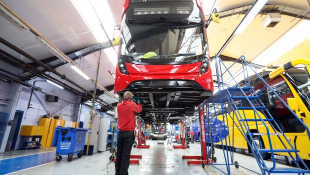 An employee works beneath the drivers cab of an Enviro 400 London bus at the Alexander Dennis Ltd. factory in Scarborough, U.K., on Wednesday, Sept. 13, 2017. Manufacturing in the U.K. rose in July for the first time this year, boosted by a strong rebound in car production. Vehicle output, which had fallen sharply in recent months, surged almost 14 percent, the most since March 2009, helped by new models rolling off production lines. 