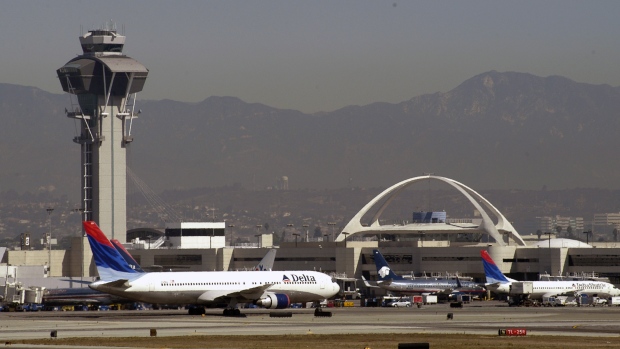 A Delta Airlines jet taxis on the runway at Los Angeles International Airport on October 13, 2005.