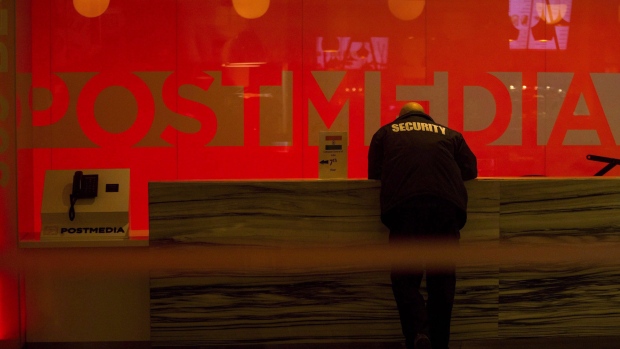A security guard stands by the front reception desk at Postmedia's Toronto headquarters