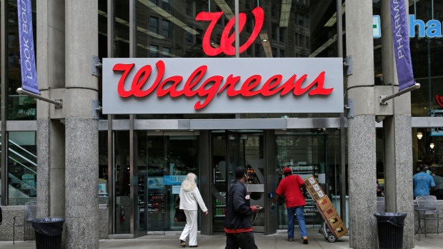  In this June 4, 2014, file photo, people walk in to a Walgreens retail store in Boston. 