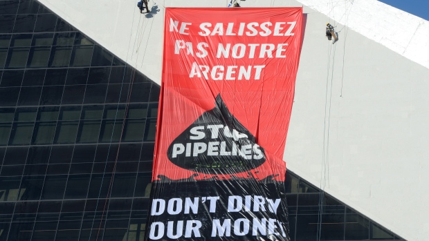 Greenpeace activists hang a banner from Olympic Stadium in Montreal