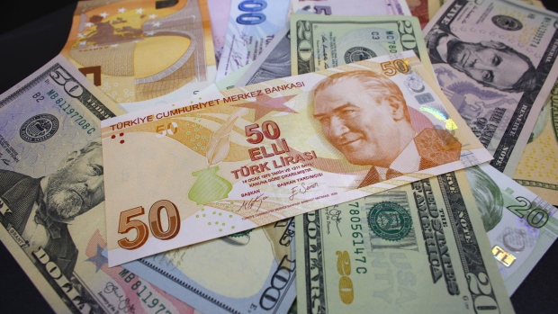 Turkish lira and dollar banknotes sit in this arranged photo at a currency exchange bureau in Istanb