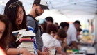 Diana Dang carries used books at a swap event in Toronto on July 21, 2012. 