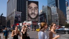 People walk by a Nike advertisement featuring Colin Kaepernick on display in New York, Sept. 5, 2018
