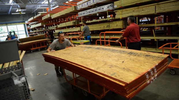 A customer pushes a cart with plywood at Home Depot ahead of Hurricane Florence in North Carolina 