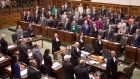 Ontario MPPs sing the national anthem as the Ontario Legislature
