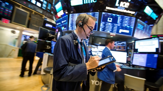 Traders work on the floor of the New York Stock Exchange (NYSE) in New York, U.S., on Monday, Oct. 2
