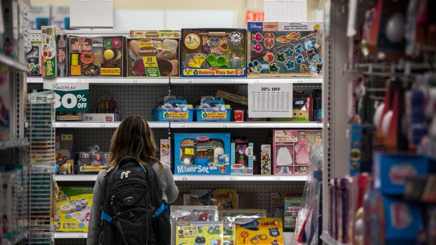 A customer views discounted merchandise displayed for sale at a Toys 'R' Us retail store at Times Square in New York, U.S., on Friday, May 11, 2018. As playtime ends for Toys 'R' Us, customers are being invited to attend the bankrupt company's final sales and snap nostalgic selfies with a Geoffrey the Giraffe banner and the #alwaysatrukid hashtag. 