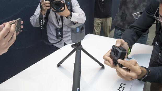 Attendees take photographs of the GoPro Inc. Fusion 360 camera during an event in San Francisco, California, U.S. 