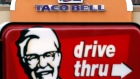 This Jan. 31, 2014, file photo, shows a Taco Bell facade behind a KFC drive-thru sign in Saugus, Mas