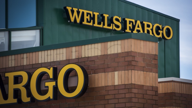 Signage is displayed outside a Wells Fargo & Co. bank branch in Palatine, Illinois, U.S., on Tuesday, July 10, 2018. Wells Fargo & Co. is scheduled to release earnings figures on July 13. 