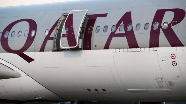 A Qatar Airways Ltd. aircraft sits parked at Chiang Mai International Airport in Chiang Mai, Thailand, on Wednesday, Dec. 13, 2017. Qatar Airways launched its new direct service from Doha to Chiang Mai today. The new seasonal service will operate 4 times a week with a flight time of just over six hours. Photograph: Taylor Weidman/Bloomberg 
