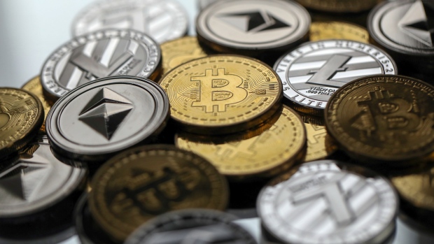 A collection of bitcoin, litecoin and ethereum tokens sit in this arranged photograph in Danbury, U.K., on Tuesday, Oct. 17, 2017. 
