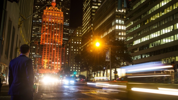 Moving traffic creates light trails as The Helmsley Building stands lit in orange to support a bid for Amazon.com Inc.'s second headquarters in New York, U.S. 