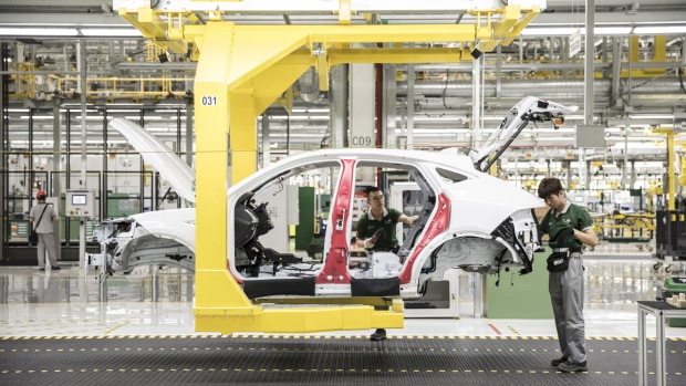 Employees assemble a Jaguar E-Pace compact sport utility vehicle (SUV) on the production line at the second phase of the Chery Jaguar Land Rover Automotive Co. plant in Changshu, China, on Wednesday, June 27, 2018. 