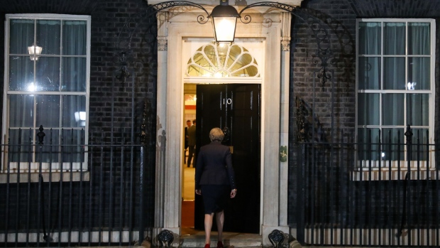 Theresa May, U.K. prime minister, returns into number 10 Downing Street after delivering a statement, following a special session of Cabinet to discuss the Brexit deal, in London, U.K., on Wednesday, Nov. 14, 2018. May will ask her divided Cabinet ministers to back her Brexit deal or quit, as the U.K.’s divorce from the European Union enters its most dangerous phase yet. 
