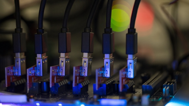 Blue data connector cables sit on a circuit board used in cryptocurrency mining machines at the SberBit mining 'hotel' in Moscow, Russia. 