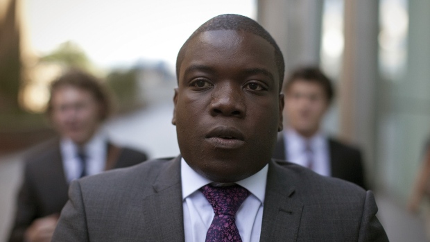 Kweku Adoboli, a former trader at UBS AG, leaves Southwark Crown Court after the court adjourned for lunch in London, U.K. 