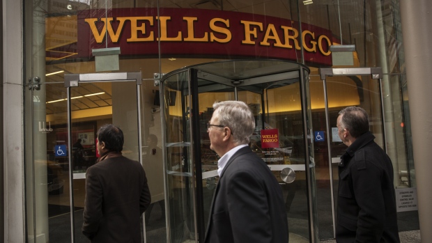 Pedestrians pass in front of a Wells Fargo & Co. bank branch in New York, U.S. 