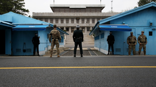 U.S. and South Korean soldiers stand guard next to the meeting rooms that straddle the border between the two Koreas in the truce village of Panmunjom in the Demilitarized Zone (DMZ) in Paju, South Korea, on Monday, April 17, 2017. 
