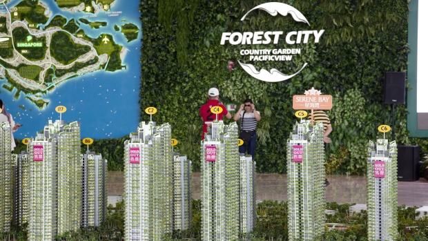 Signs reading "Sold Out" are displayed on model towers of the Forest City development at the Country Garden Holdings Co. property showroom in Iskandar Malaysia zone of Johor Bahru, Johor, Malaysia, on Tuesday, Nov. 02, 2016. While Chinese home buyers have sent prices soaring from Vancouver to Sydney, in this corner of Southeast Asia it's Chinas developers that are swamping the market, pushing prices lower with a glut of hundreds of thousands of new homes. They're betting that the city of Johor Bahru, bordering Singapore, will eventually become the next Shenzhen. 