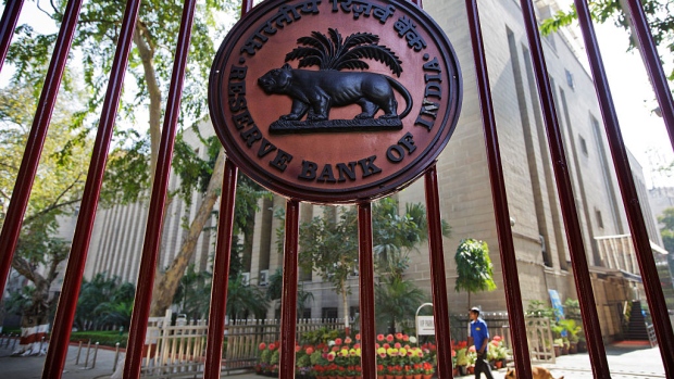 The Reserve Bank of India (RBI) logo is displayed on a gate at the central bank's headquarters in New Delhi, India, on Sunday, March 22, 2015. Jaitley said he discussed plans to combine India's stock and commodities market regulators in a meeting with the Securities and Exchange Board of India, according to comments made to reporters in New Delhi. 