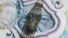 The Elizabeth Tower, also known as Big Ben, and a portrait of Queen Elizabeth II are seen on a British five pound banknote, in this arranged photograph in London, U.K., on Thursday, Oct. 13, 2016. The U.K. currency is getting harder to trade, and to predict, because the nation’s exit from the European Union has changed the rules of engagement. 