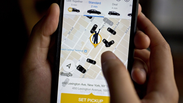 The Gett Inc. application is demonstrated for a photograph on an Apple Inc. iPhone in Washington, D.C., U.S., on Thursday, April 27, 2017. Two small ride-hailing companies are combining in an effort to slow the march of Uber Technologies Inc. around the globe. Tel Aviv-based Gett said its paying $200 million to acquire Juno, a New York startup that endeared itself to drivers by offering company stock and better pay than Uber. 