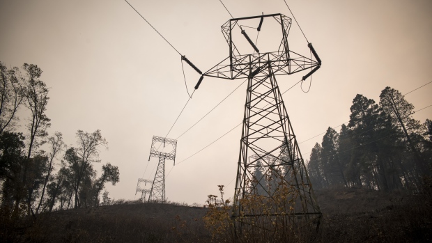 Transmission towers stand in a valley outside Paradise, California, U.S., on Tuesday, Nov. 13, 2018. The Camp Fire north of Sacramento has now killed at least 42 people, injured three firefighters and destroyed 6,500 homes, CalFire said Tuesday morning. 