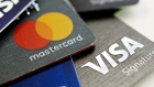 Visa Inc. and Mastercard Inc. credit cards are arranged for a photograph in Tiskilwa, Illinois, U.S., on Tuesday, Sept. 18, 2018. Visa and Mastercard agreed to pay as much as $6.2 billion to end a long-running price-fixing case brought by merchants over card fees, the largest-ever class action settlement of an antitrust case. 
