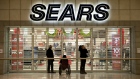 Shoppers wait for a Sears Holdings Corp. store to open ahead of Black Friday in Peoria, Illinois, U.S., on Thursday, Nov. 28, 2013. 