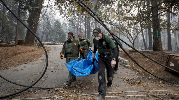 California officers remove the remains of a victim of the Camp Fire in Magalia on Nov. 15. 