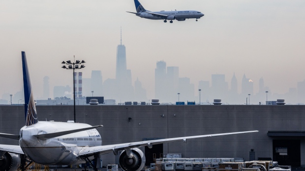 A United airplane prepares for landing as the New York City skyline stands in the background at Newark Liberty International Airport (EWR) in Newark, New Jersey, U.S., on Wednesday, April 12, 2017. 