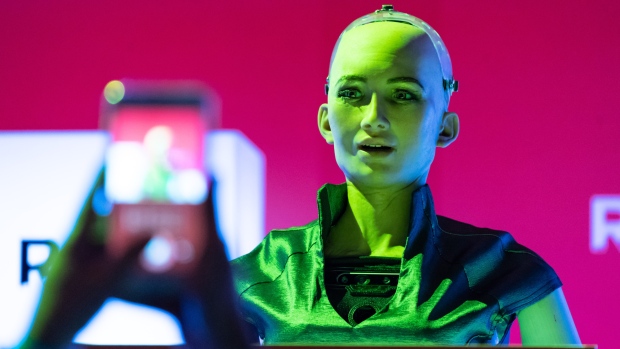 An attendee takes a photograph of Hanson Robotics Inc. humanoid robot "Sophia" during the Rise conference in Hong Kong, China. 