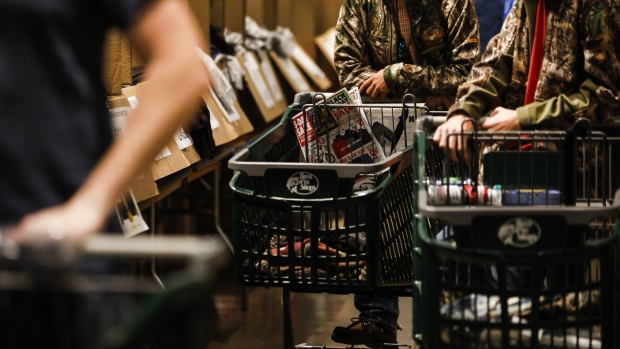 Shoppers push carts inside a Bass Pro Outdoor World LLC store on Black Friday in Tampa, Florida, U.S., on Friday, Nov. 23, 2018. Deloitte expects sales from November to January to rise as much as 5.6 percent, to more than $1.1 trillion, marking the best holiday period in recent memory. 