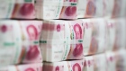 Genuine bundles of Chinese one-hundred yuan banknotes are arranged for a photograph at the Counterfeit Notes Response Center of KEB Hana Bank in Seoul, South Korea. 