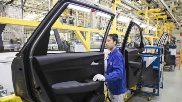 An employee inspects a door panel in the general assembly shop at the SAIC-GM-Wuling Automobile Co. Baojun Base plant, a joint venture between SAIC Motor Corp., General Motors Co. and Liuzhou Wuling Automobile Industry Co., in Liuzhou, Guangxi province, China, on Wednesday, May 23, 2018. GM and its partners sold 4 million vehicles in China in 2017, about 1 million more than the automaker sold in the U.S. 