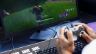 An attendee plays in the Epic Games Inc. Fortnite: Battle Royale Celebrity Pro Am in Los Angeles on June 12, 2018.  Photographer: Patrick T. Fallon/Bloomberg