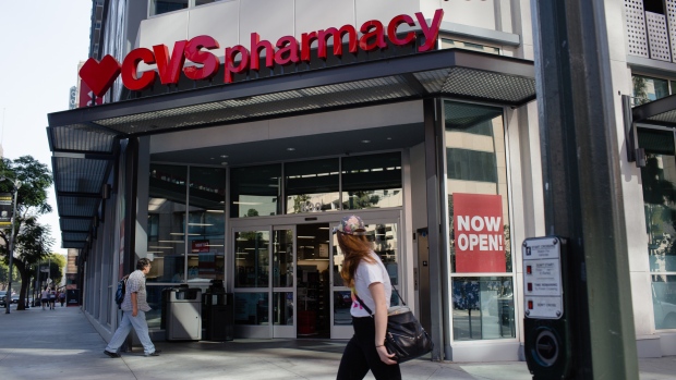 A customer walks towards the entrance of a CVS Health Corp. store in downtown Los Angeles, California, U.S., on Friday, Oct. 27, 2017. 