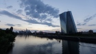 The European Central Bank (ECB) skyscraper headquarters stand beside the River Main at dusk in Frankfurt, Germany. 