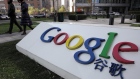Pedestrians walk past the Google Inc. logo displayed outside the building housing the company's China headquarters in Beijing, China, on Monday, Nov. 12, 2012. Google Inc. reported higher traffic patterns on its sites in China after the company earlier said there was an unusual decline in the country, and an Internet monitor said company services were blocked there. 