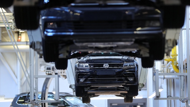 Cradles transport Volkswagen Touran R-Line Sport Utility Vehicles (SUV) on the assembly line at the Volkswagen AG (VW) factory in Wolfsburg, Germany, on Tuesday, Oct. 30, 2018. VW has managed one of the more confident outlooks in an otherwise gloomy reporting season for carmakers and suppliers. 